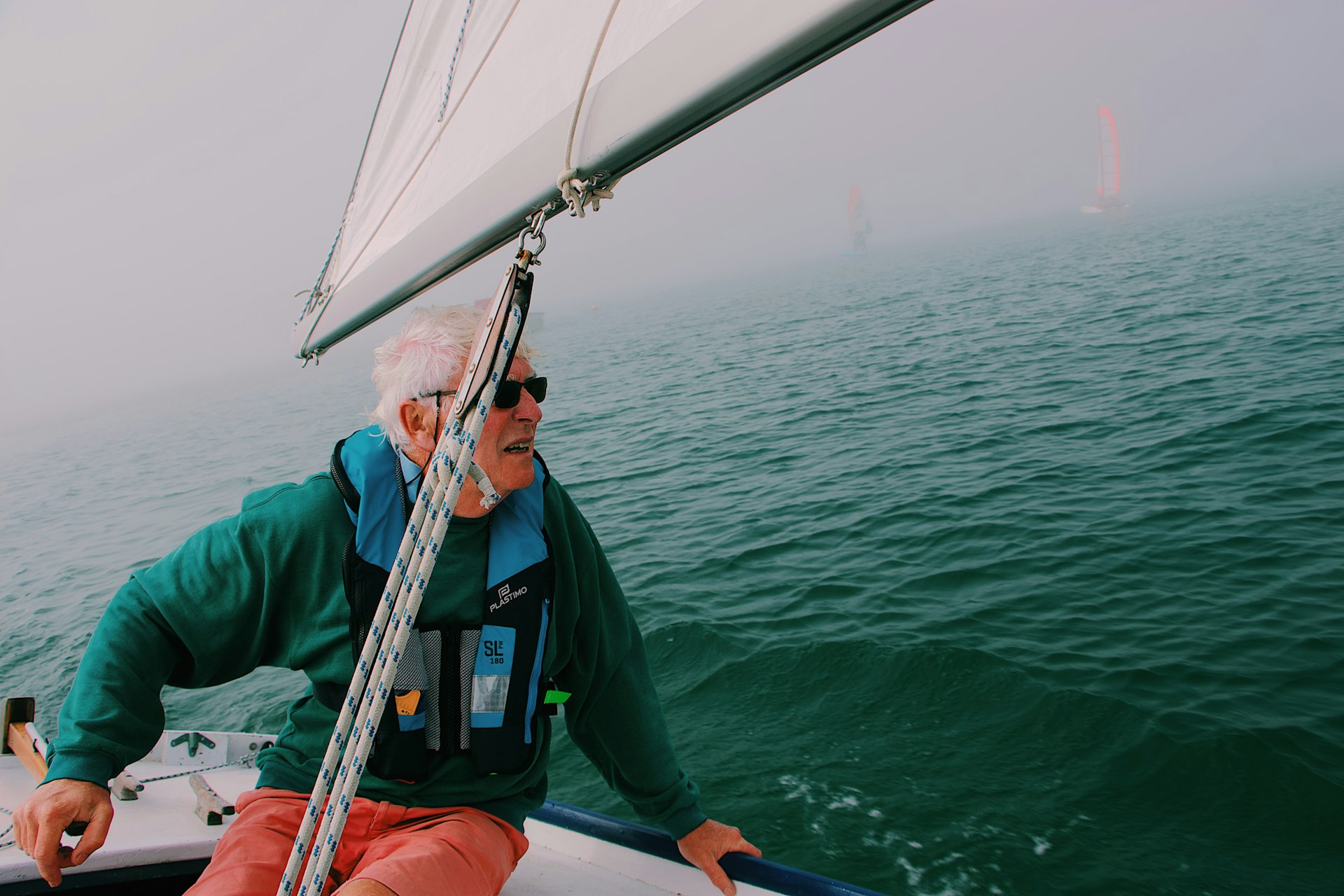 Sailboat cruising along a scenic coastline