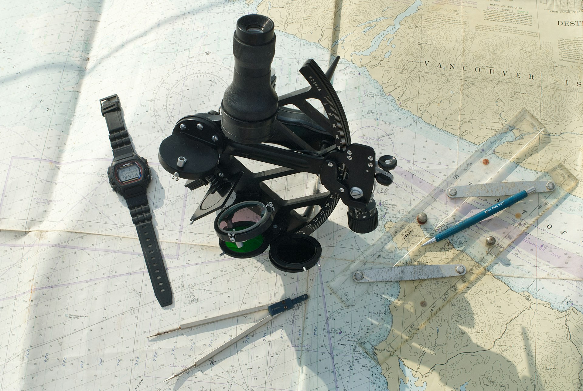 Nautical chart of Vancouver Island with navigation instruments and sextant